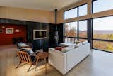 The living room features a cylindrical modern stove with a black sheet steel surround.