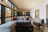 The upper floor of the new volume contains the living/dining/kitchen, with a whole wall of north-facing windows to look out to the scenery.