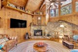 The granite boulder at the heart of the living room was incorporated into the home's original design, blending architecture with landscape.