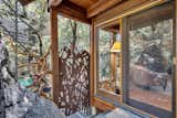 One of two sculpted gates by artist Dore Capitani, this custom piece leads from the main deck to the forested lower property—equal parts art and function.