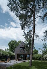 The cottage seen from the main road, with a thoughtfully designed garden that enhances its aesthetic and connection to the landscape.