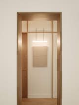 Archway to corridor featuring bespoke wall light