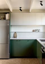 After: The once-basic kitchen now features deep green cabinets, Oyster Grey benches, and a Nagoya Mosaic tile splashback. Bosch appliances and Linear Standard pulls turn a utilitarian space into the heart of the home.