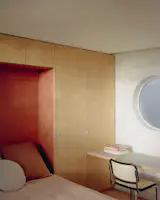 The Murphy bed folds down over a red panel and turns it into a guest room