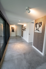 A dramatic 27-foot glass curtain wall replaced a rear hallway, transforming it into a light-filled  art gallery corridor that blurs the boundary between interior and exterior.