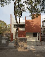 Front view of the building with the African tulip tree