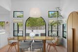 Morning sunlight bathes the dining room while it opens wide to the backyard for evening enjoyment.