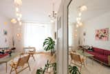 A mirrored reflection reveals another view of the living room, capturing its vintage charm and sculptural lighting.