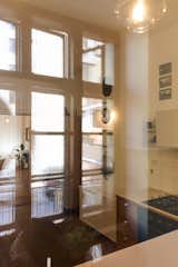 Multiple reflections of the kitchen window create a layered visual effect.