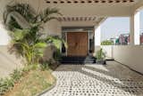 This passage, flanked by sculpted greens, draws one towards the main entrance.