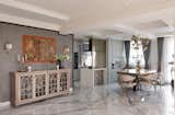 Kalamkari Ganesh Ji artwork takes center stage in the console wall, featuring fluted glass sandwiched with grey metal wire mesh, adding depth and visual intrigue.