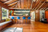 Guest cottage with exposed timber trusses, soapstone stove, custom illuminated bar and bench seating—blend of rustic warmth and functional design.

Well and Wood-Stove: Ready for off-grid or backup power system.