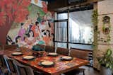 The community table top is made of orange, red, yellow and green mosaic as a  continuation of the art. The tiles are an abstract of fallen flowers of the gulmohar tree. 
