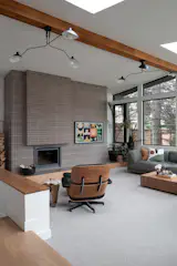 The “cabin room” was love at first sight—a sunken space wrapped in windows and skylights that frame views of the Red River and towering old-growth spruce. A Stûv wood-burning fireplace brings steady warmth through the winter, while a new white oak pony wall adds both function and texture, wrapping the room in natural materiality. It’s a cozy, light-filled retreat that feels miles from the city.