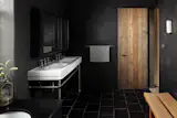 Black tadelakt adorns the walls of the family bathroom 