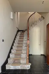 Hallway featuring the original staircase and reclaimed stone flooring