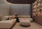 The sofa here is a curved 'Track Sofa' by Artifort, with dressed shelving to one side in muted brown Valcromat