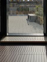 A bespoke window manifestation along the glazing made up of rhythmic vertical lines