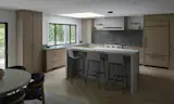 Wide view of the redesigned kitchen where removing dividing walls created an open connection to the dining area. The island replaces the former cook-top zone and provides seating, prep space, and visual continuity across the new layout.